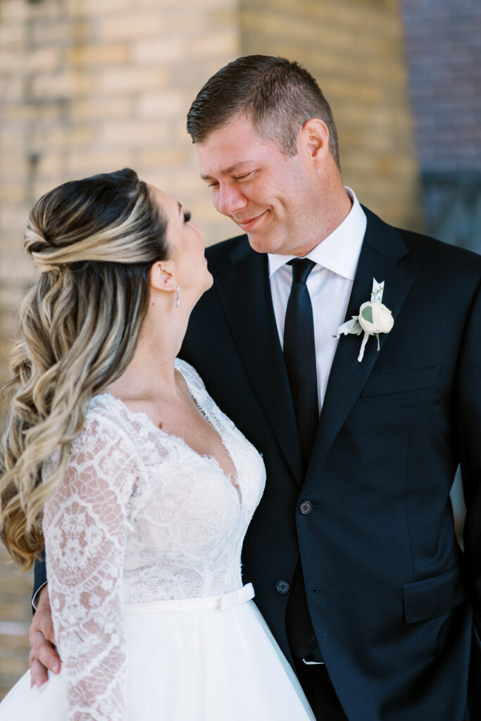 bride and groom looking at each other with a smile. This is at Aster Cafe in Minneapolis.