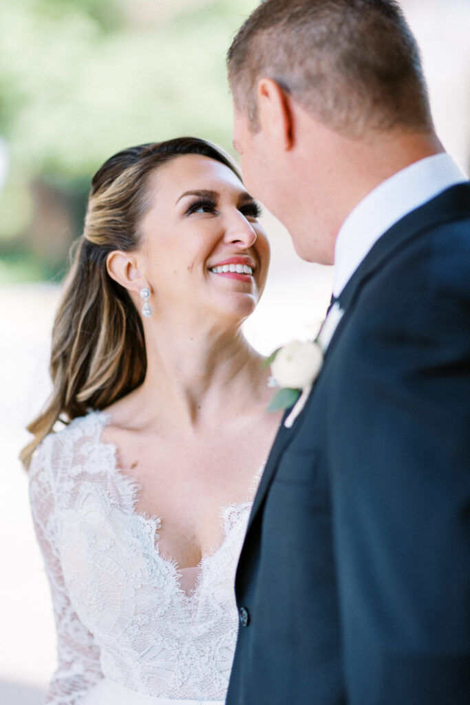 Close-up of bride looking at groom in Aster Cafe in Minneapolis, Minnesota. The bride looks like she is amazed and in awe of the groom. Captured by Toly Dzyuba Photography.