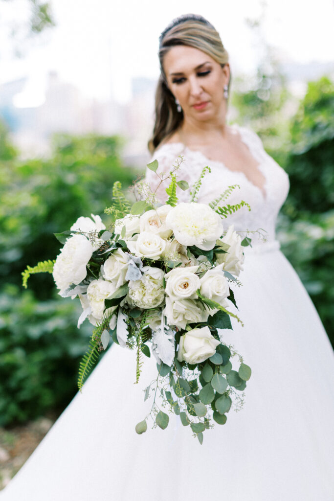 The bride is holding her elegant wedding bouquet.