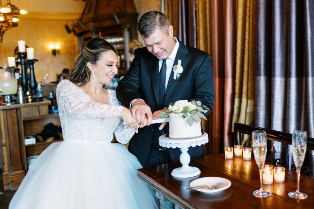 Just married couple cutting their wedding cake at Aster Weddings & Events.