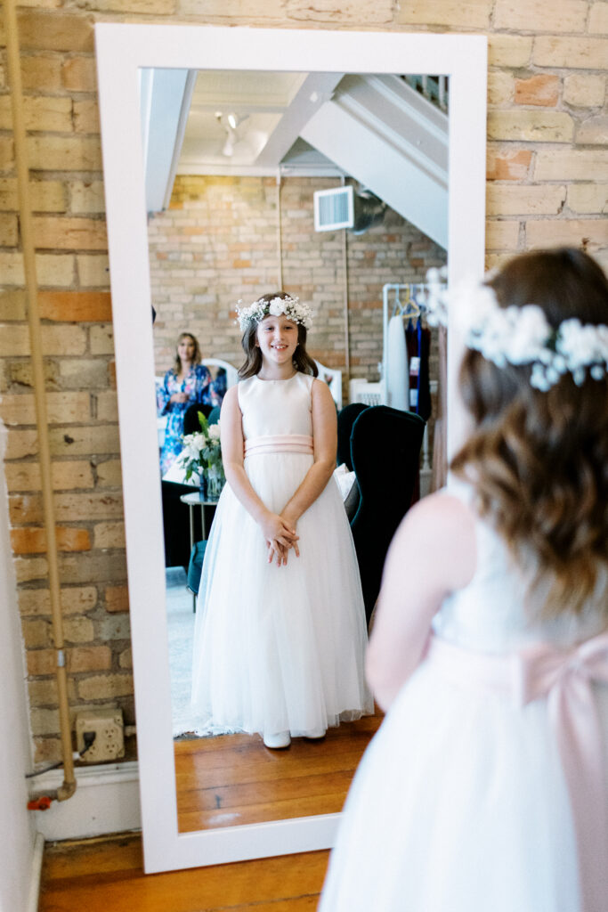 Flower girl in the mirror at Aster Weddings & Events wedding