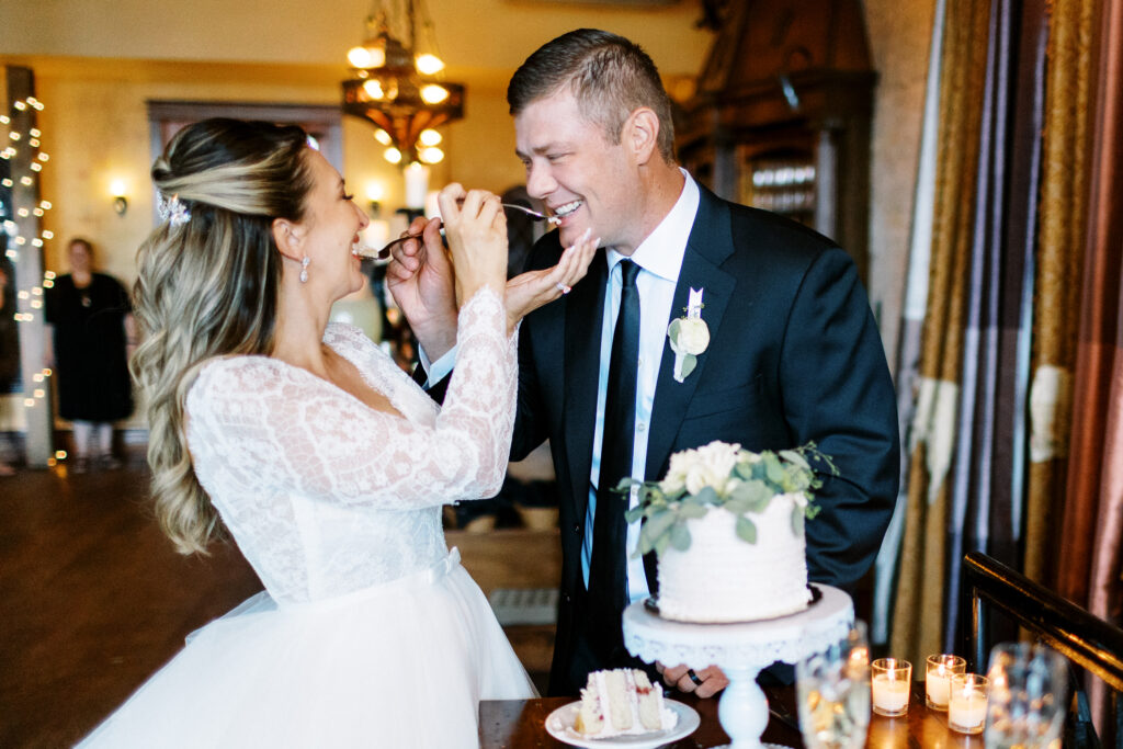 Minneapolis wedding photographer photographing cake cutting and feeding