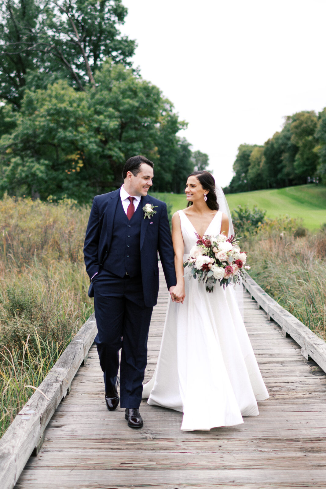 Sarah and Tony walked hand-in-hand along the boardwalk, looking lovingly into each other's eyes and smiling. It was a perfect moment on their wedding day.