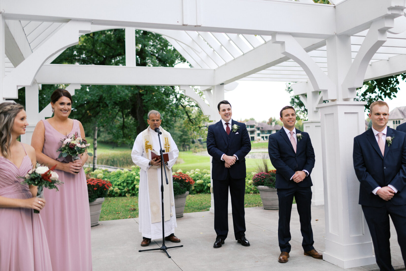 The groom sees his bride for the first time as she walks down the aisle. The look on his face is priceless.