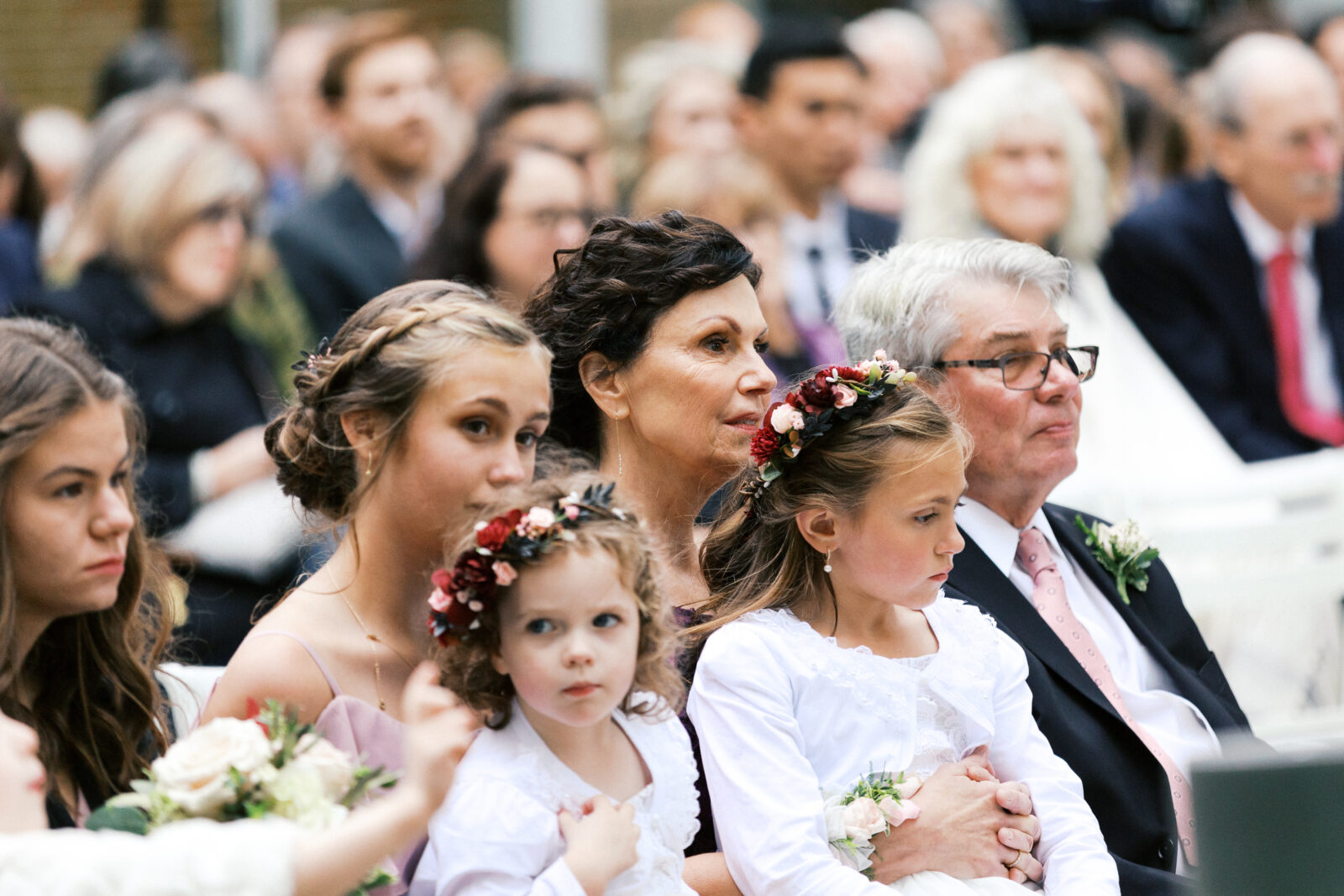 Minnesota wedding photographer is capturing ceremony moments with two flower girls in the frame