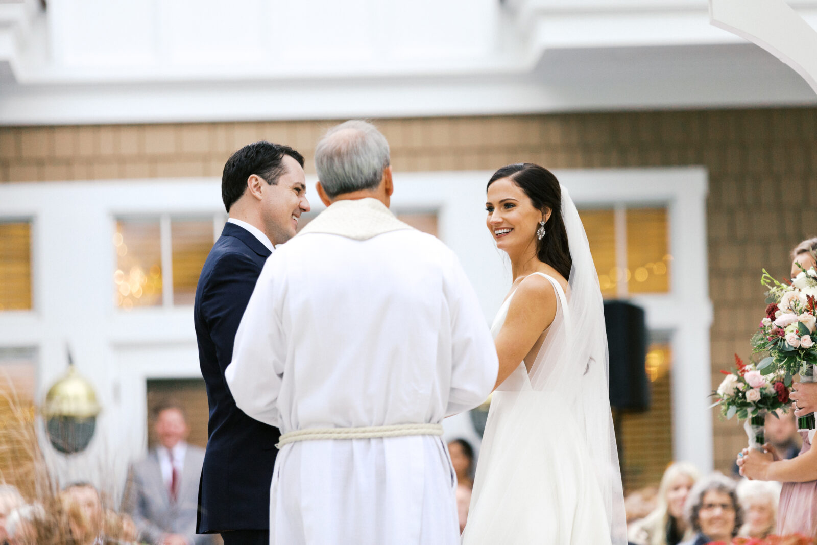 bride and groom with smiles on their face at the ceremony