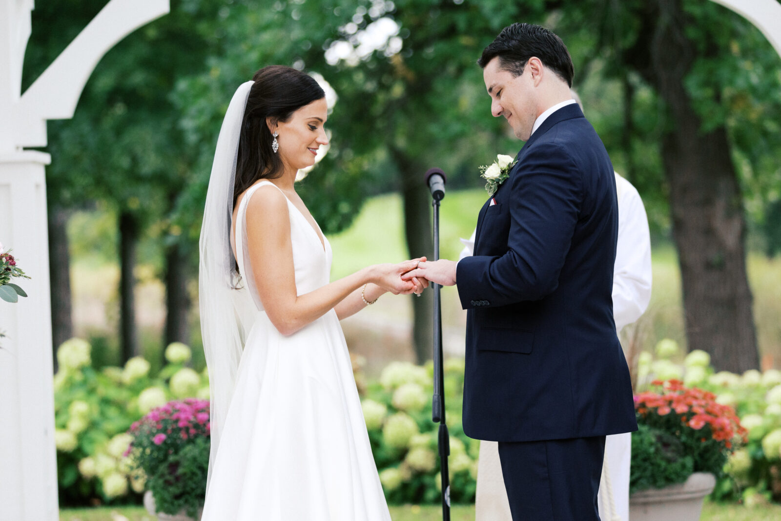 Bride and groom exchanging their rings at the ceremony.
