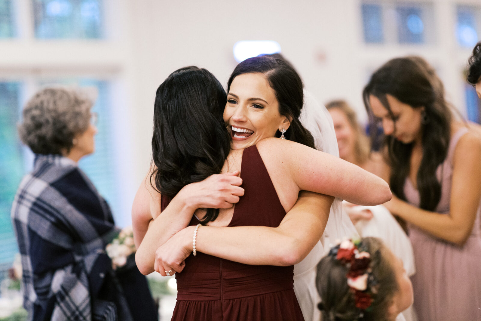 Bride receiving a hug from her guest.