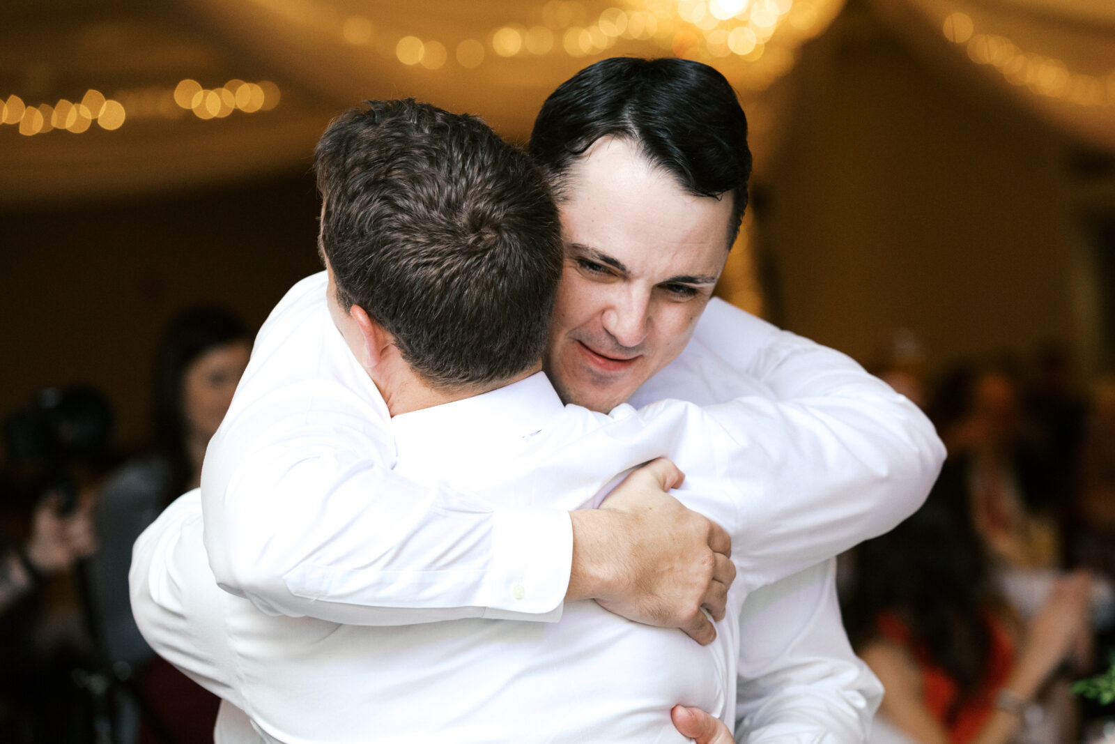 Groom is hugging his friend