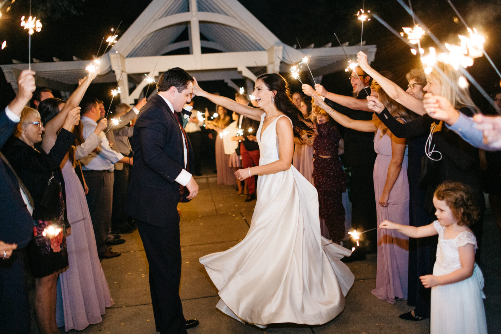 The bride and groom dance at their wedding reception at Bearpath Golf and Country Club. Sparklers add a touch of magic to the moment.