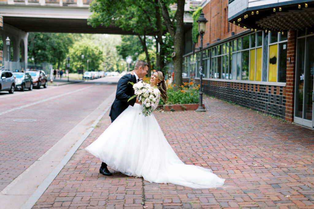 Groom is dipping his bride in the middle of the city in Minneapolis.