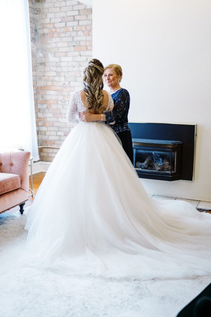 Mom and daughter moment before the first look with joy and tears.