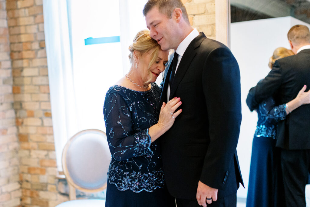 Mom is hugging her son with tears at 
Aster Weddings & Events wedding