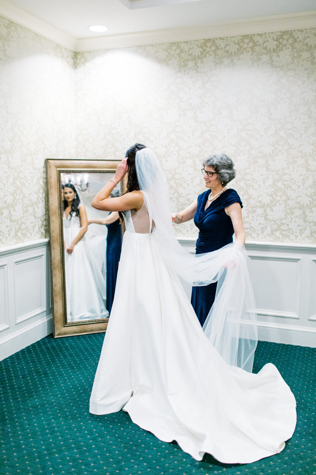 Mom is helping the bride with her dress