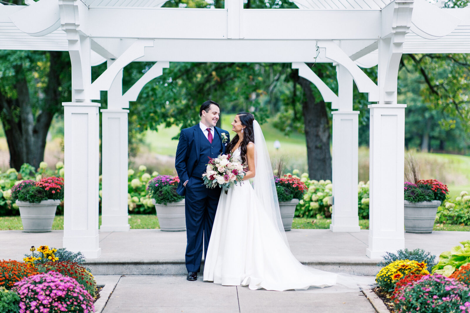 Bride and groom looking at each other smiling