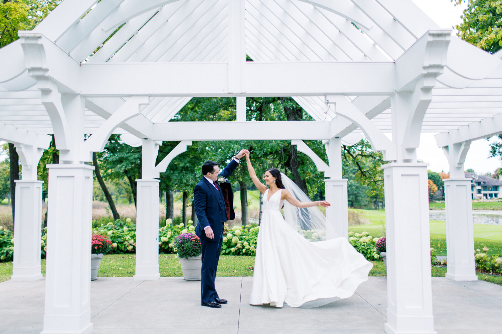 Bride is dancing with him holding her hand at Bearpath Golf and Country Club