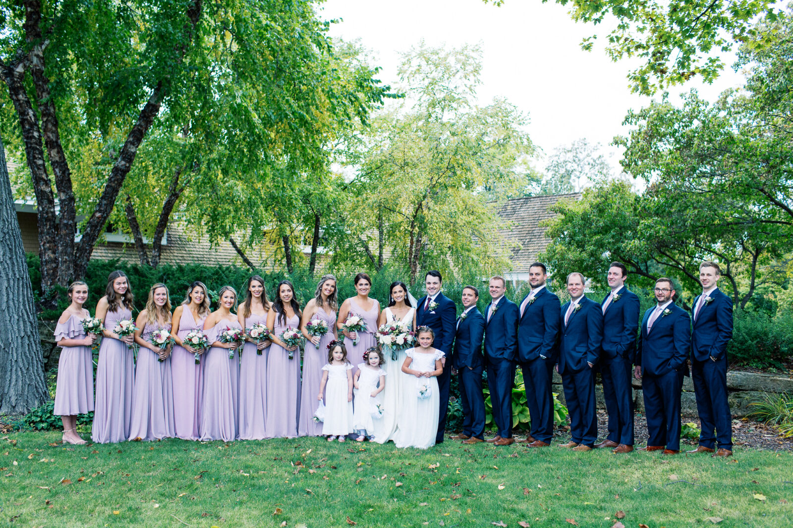 Toly Dzyuba Photography is capturing the portrait of the wedding party at the Bearpath