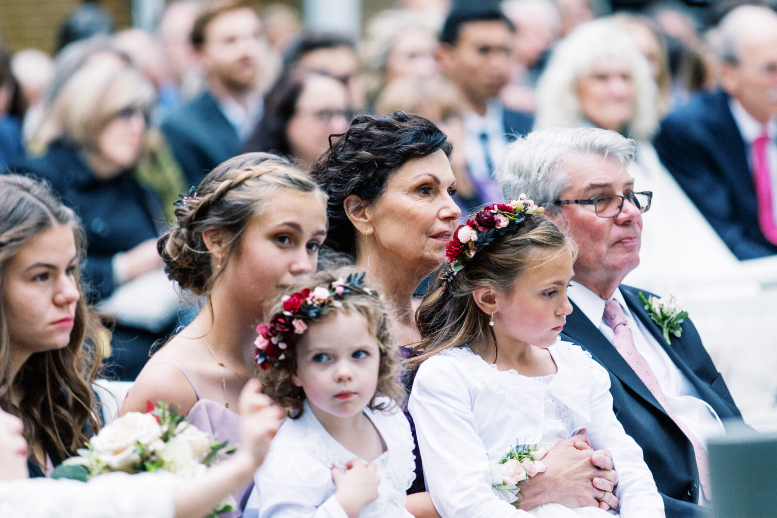 Minnesota wedding photographer is capturing ceremony moments with two flower girls in the frame