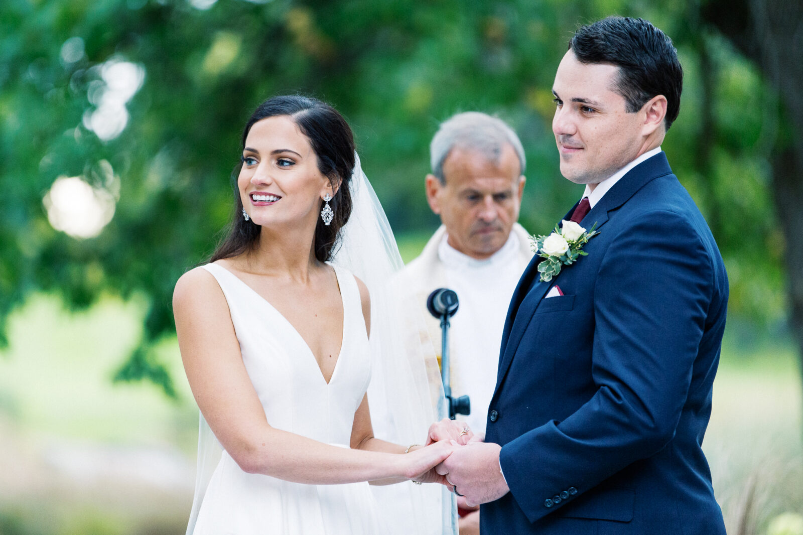 bride and groom holding their hands during the instrument play