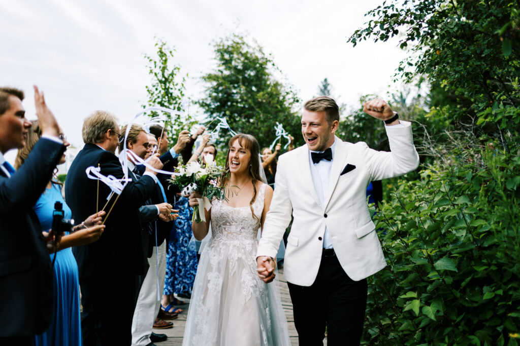 Grand exit captured by a Minnesota wedding photographer at Bluefin Bay Resort on the North Shore, with the bride and groom walking through a tunnel of sparklers.