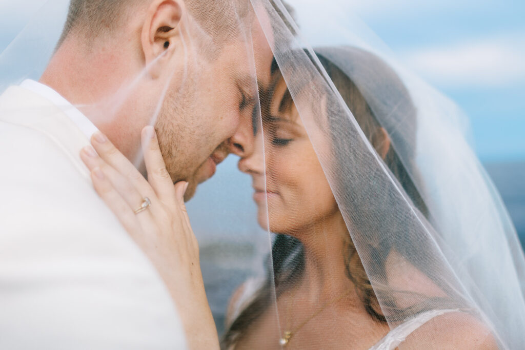 Close-up of a bride and groom gently touching foreheads, sharing an intimate moment of North Shore