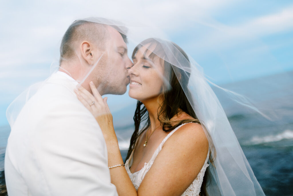 Groom kissing his bride at Bluefin Bay Family Resort