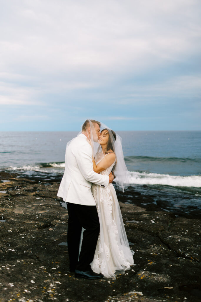 Groom kissing his bride of North Shore