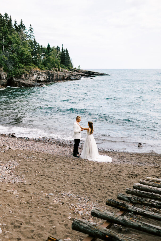 Bride and Groom in private pronouncing their vows to each other on the beach of North Shore.