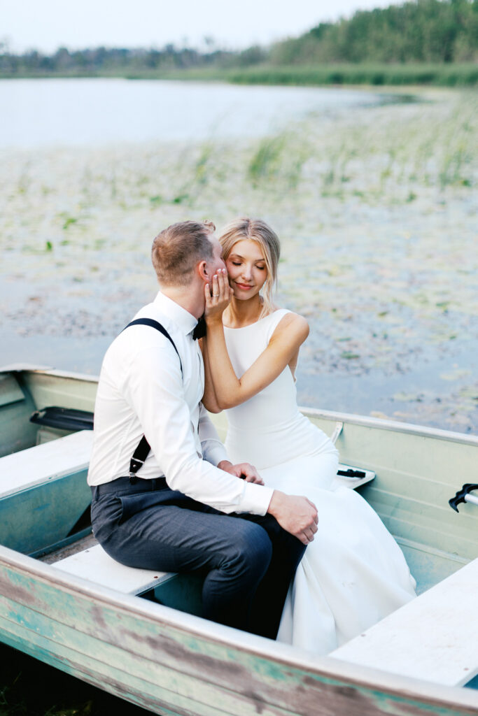 Photographing intimate moment of Cody kissing Sophia on the detroit lakes. Captured by Toly Dzyuba Photography.