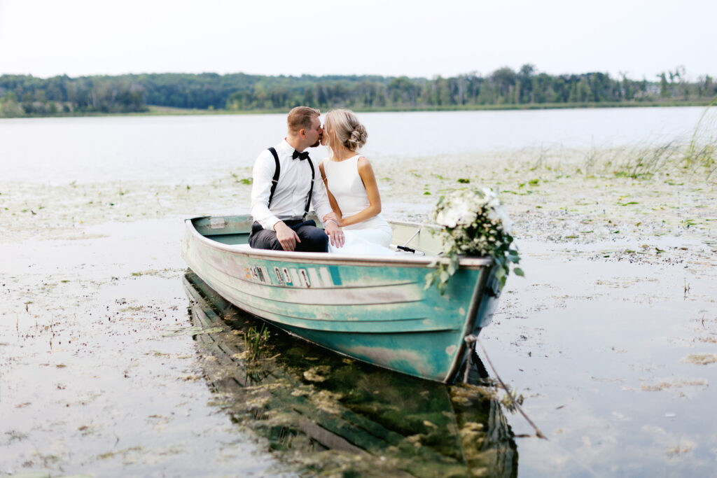 Capturing intimate moment of Bride and Groom kissing in the boat, Minnesota Wedding Photographer captures the moment.