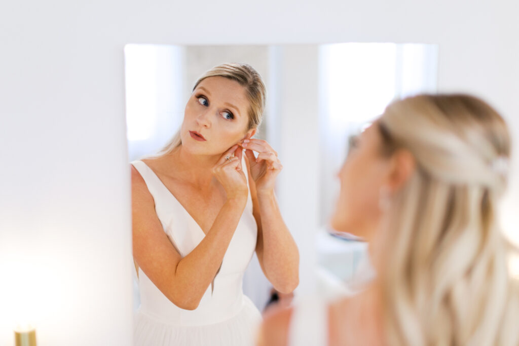 Bride is putting on her earings