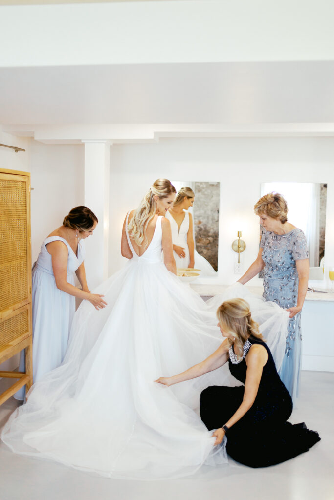 The reflection in the mirror of the bride getting ready in her wedding dress at Ivory North.