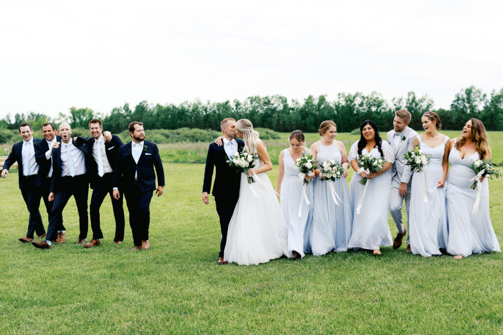 Wedding party strolling through Ivory North fields. By Toly Dzyuba Photography - Minnesota wedding photographer