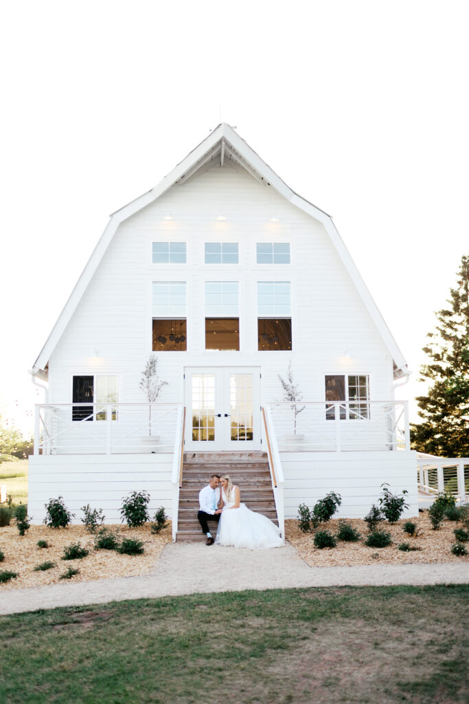 Ivory North at sunset and newlyweds sitting at the rustic barn.