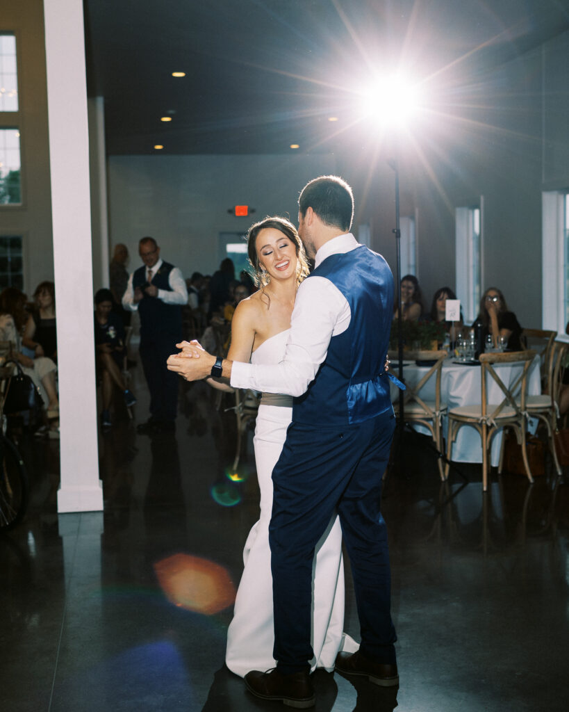 Bride and groom sharing their first dance at Abella Weddings and Events in Minnesota, captured in a romantic moment as the bride closes her eyes, photographed by a Minnesota wedding photographer