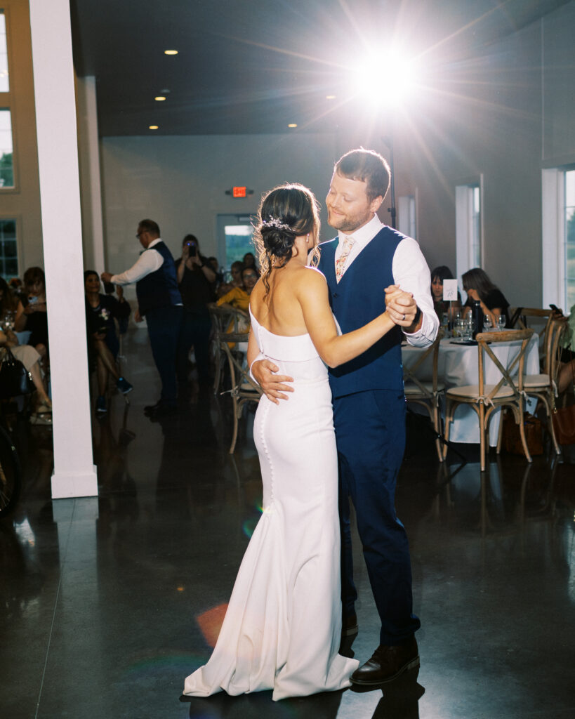Bride and groom sharing their first dance with joy and smiles at Abella Weddings and Events in Minnesota, photographed by a Minnesota wedding photographer.