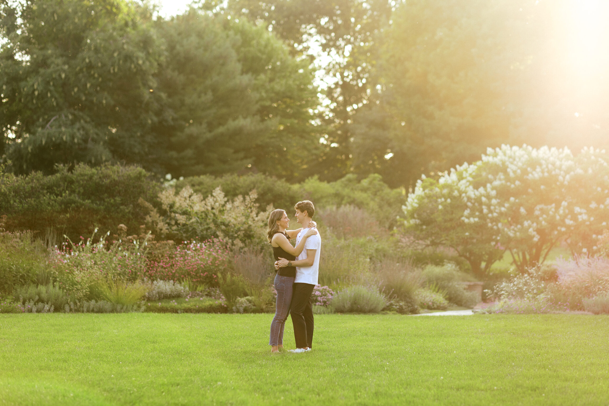 With their eyes at each other, the couple soaks in the beauty of the sunset at Noerenberg Gardens. Captured by Toly Dzyuba Photography, your trusted Minneapolis wedding photographer.