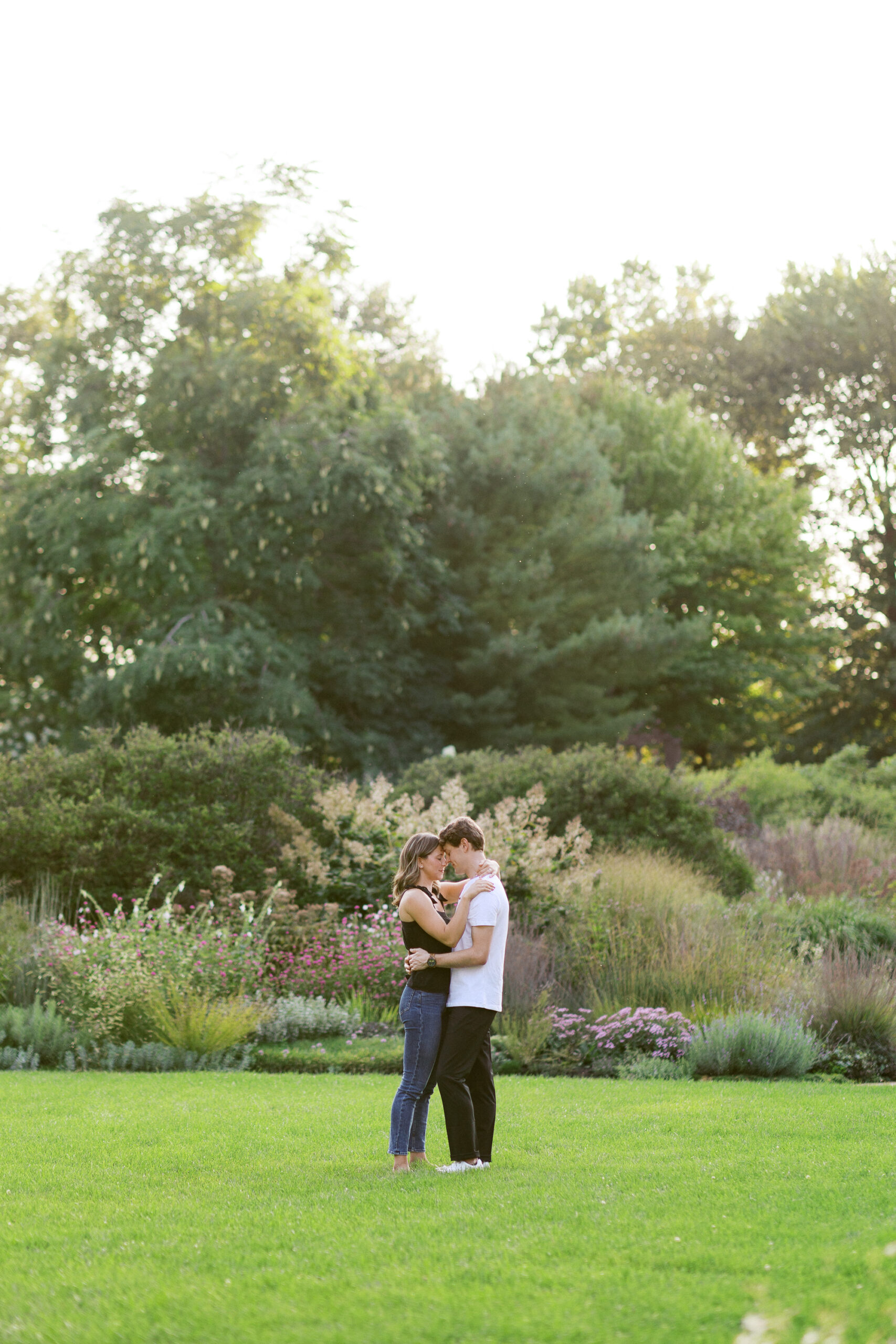 With their heads together and eyes closed, the couple soaks in the beauty of the sunset at Noerenberg Gardens. Captured by Toly Dzyuba Photography, your trusted Minneapolis wedding photographer.