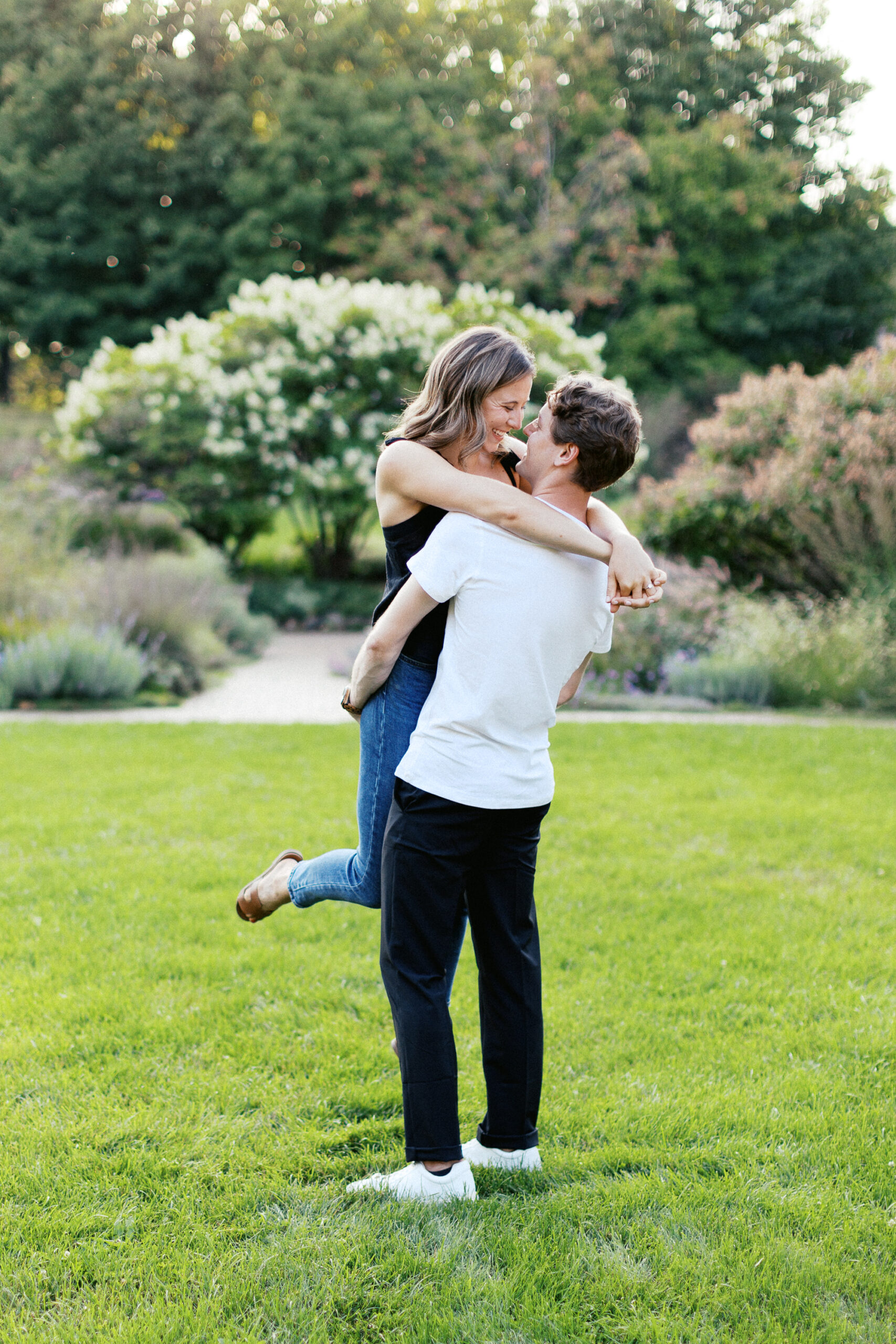 He picks her up in the gardens, filled with smiles and laughter as the sunset creates a beautiful backdrop. Captured by Toly Dzyuba Photography.