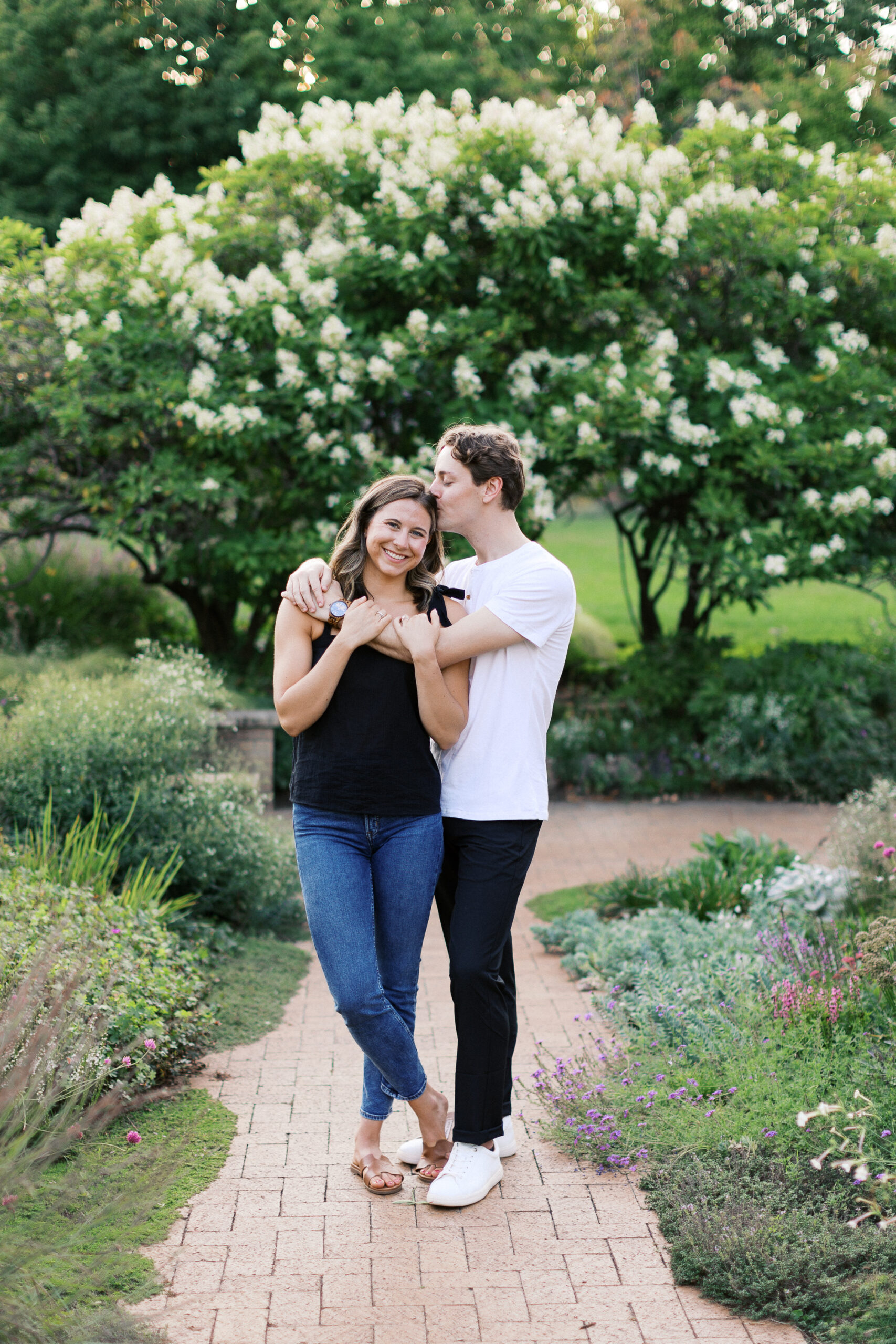 He gently kisses her on the head at Noerenberg Gardens, capturing a tender and loving moment. Captured by Toly Dzyuba Photography.