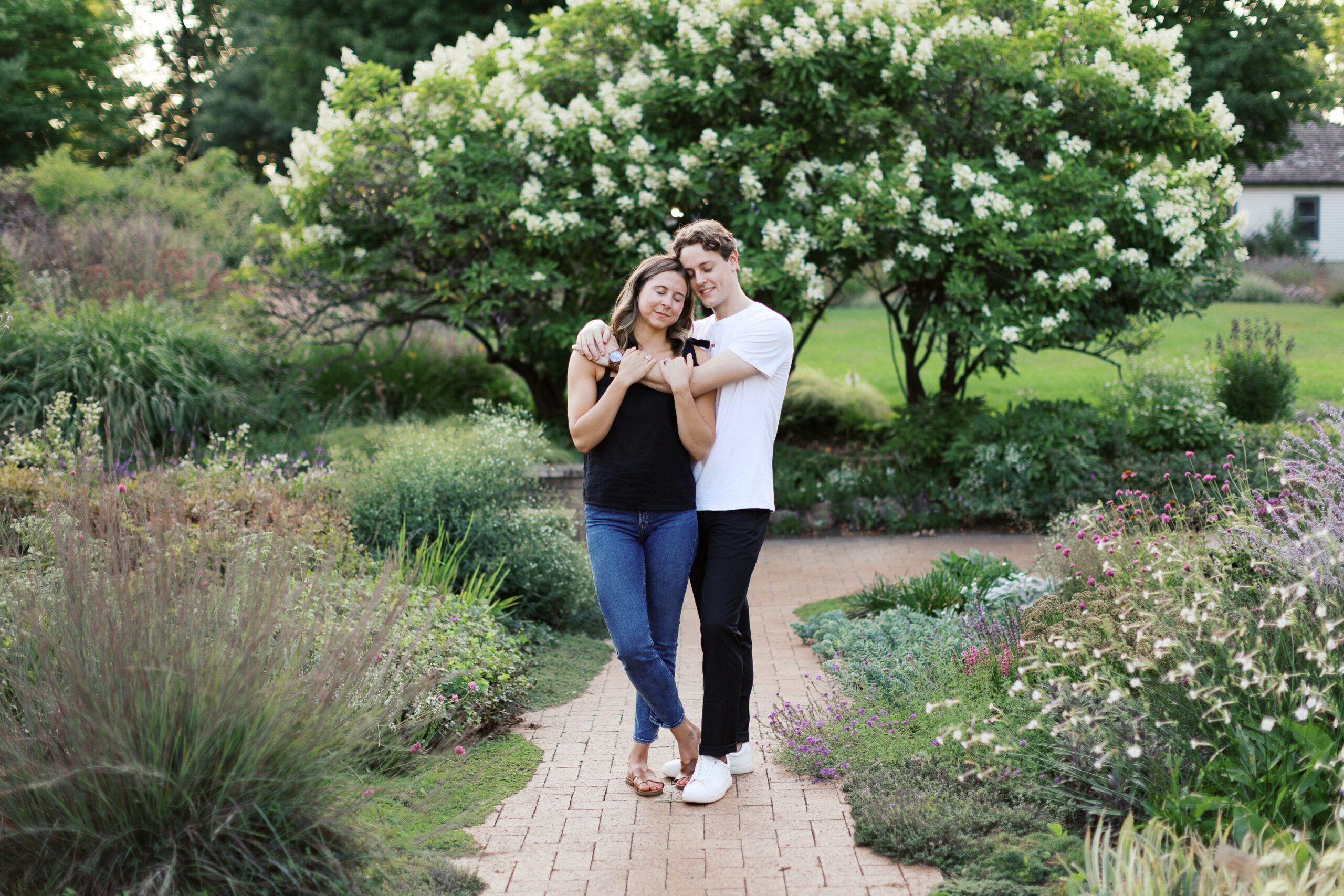 He hugs her gently in his arms with his eyes closed as they stand together at Noerenberg Gardens, sharing a peaceful, intimate moment. Captured by Toly Dzyuba Photography.