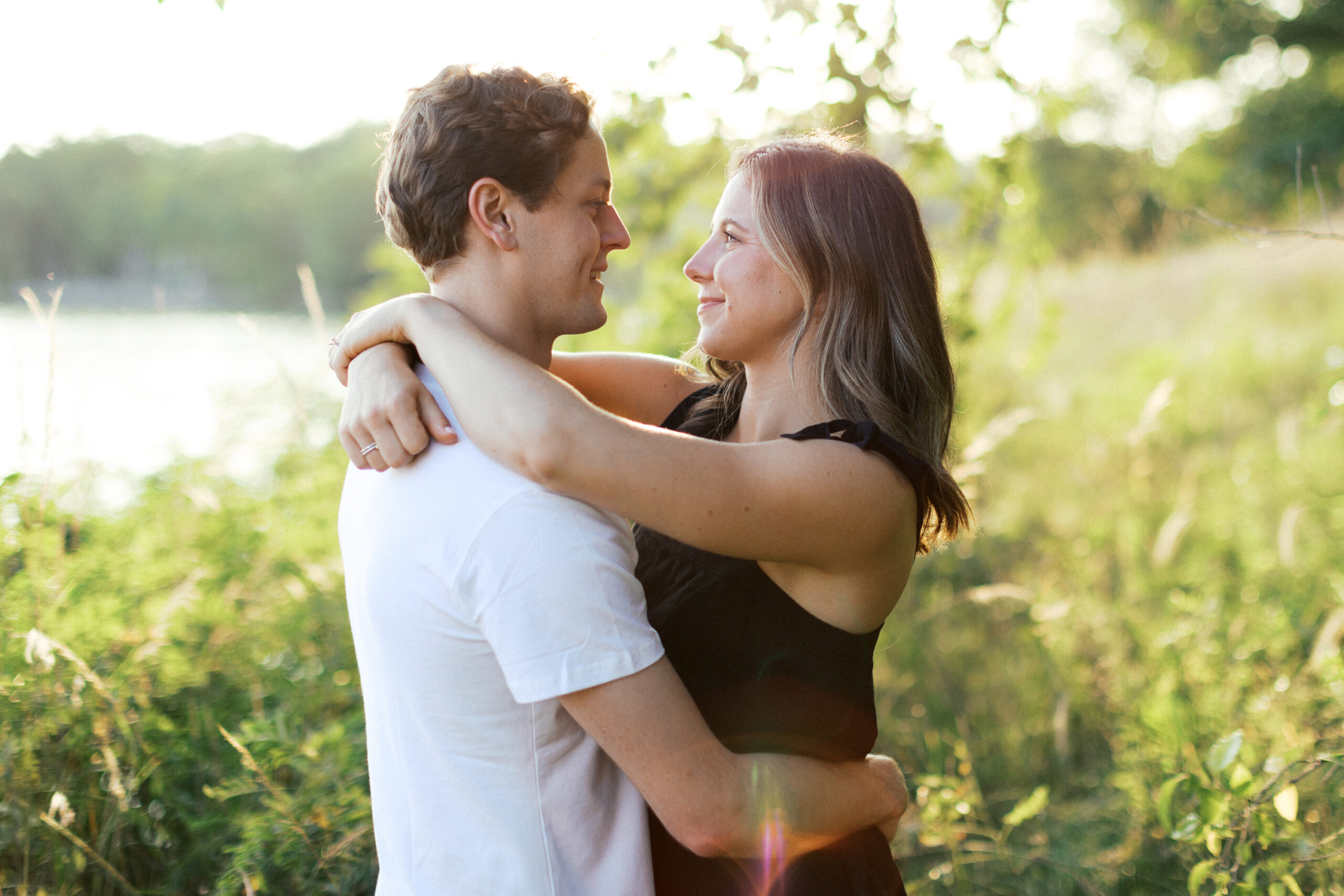 A loving embrace as the couple looks at each other, sharing a joyful smile. Captured by Toly Dzyuba Photography.