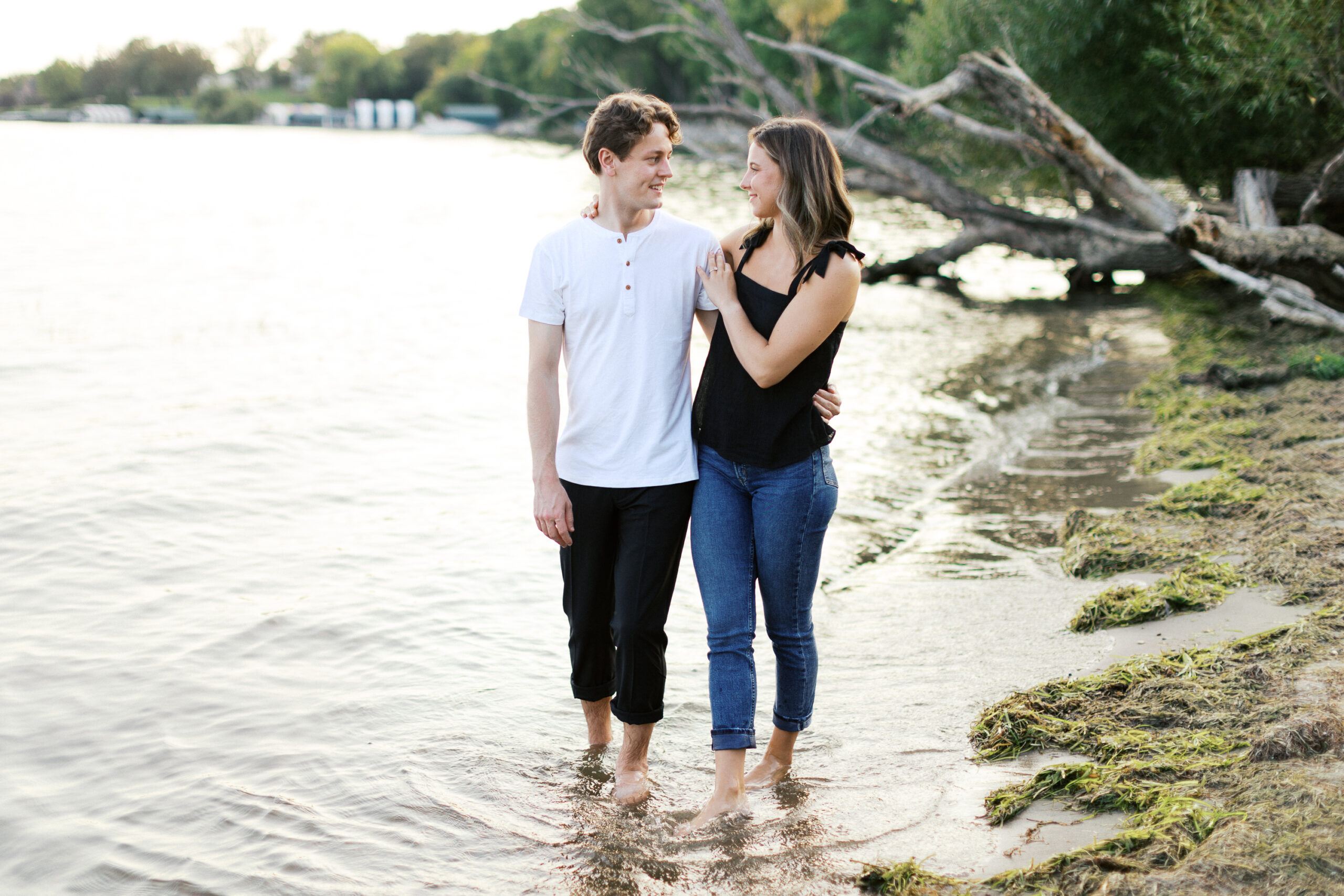 "A romantic sunset moment at Noerenberg Gardens as the barefoot couple walks through the lake, smiling and gazing into each other’s eyes. Captured by Toly Dzyuba Photography.