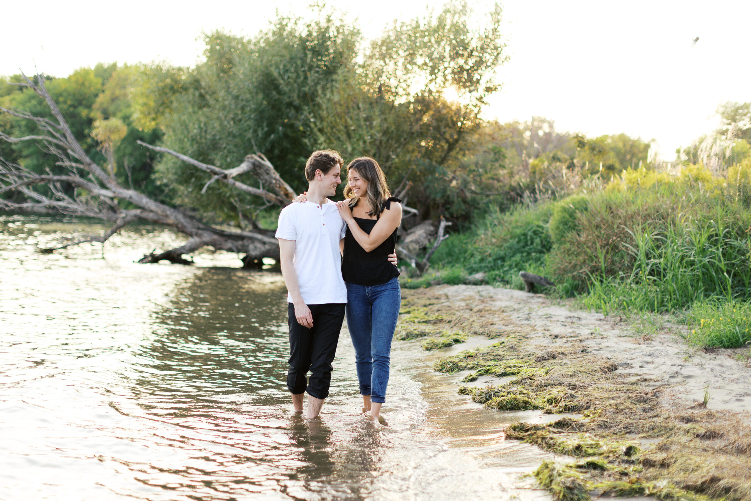 "A romantic sunset moment at Noerenberg Gardens as the barefoot couple walks through the lake, smiling and gazing into each other’s eyes. Captured by Toly Dzyuba Photography.