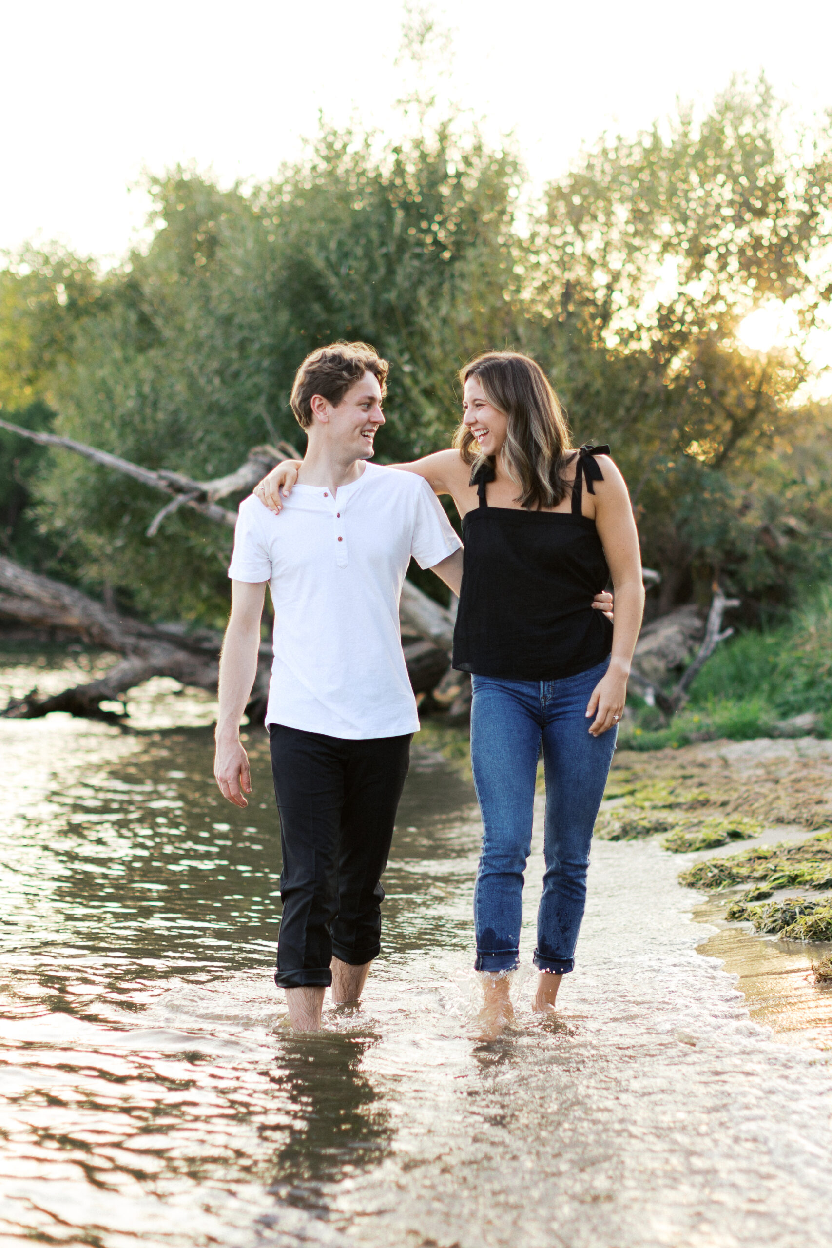 "A romantic sunset moment at Noerenberg Gardens as the barefoot couple walks through the lake, smiling and gazing into each other’s eyes. Captured by Toly Dzyuba Photography.