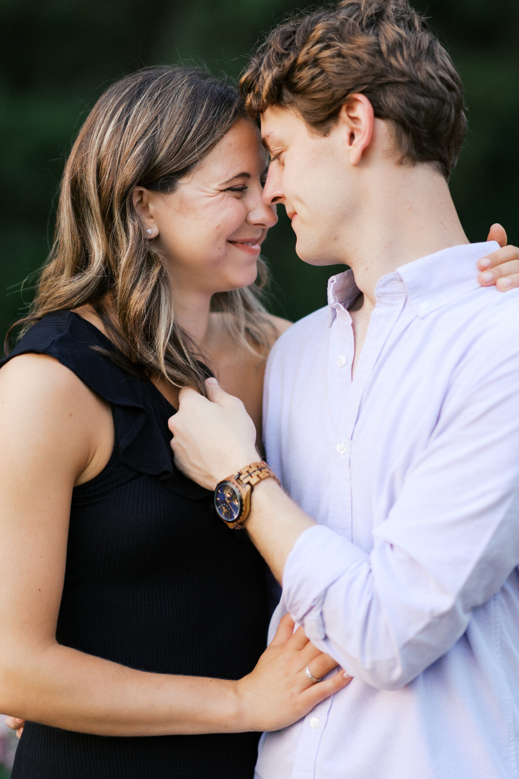 A sweet and intimate moment as the couple touches heads and smiles, radiating love and joy. Captured by Toly Dzyuba Photography.