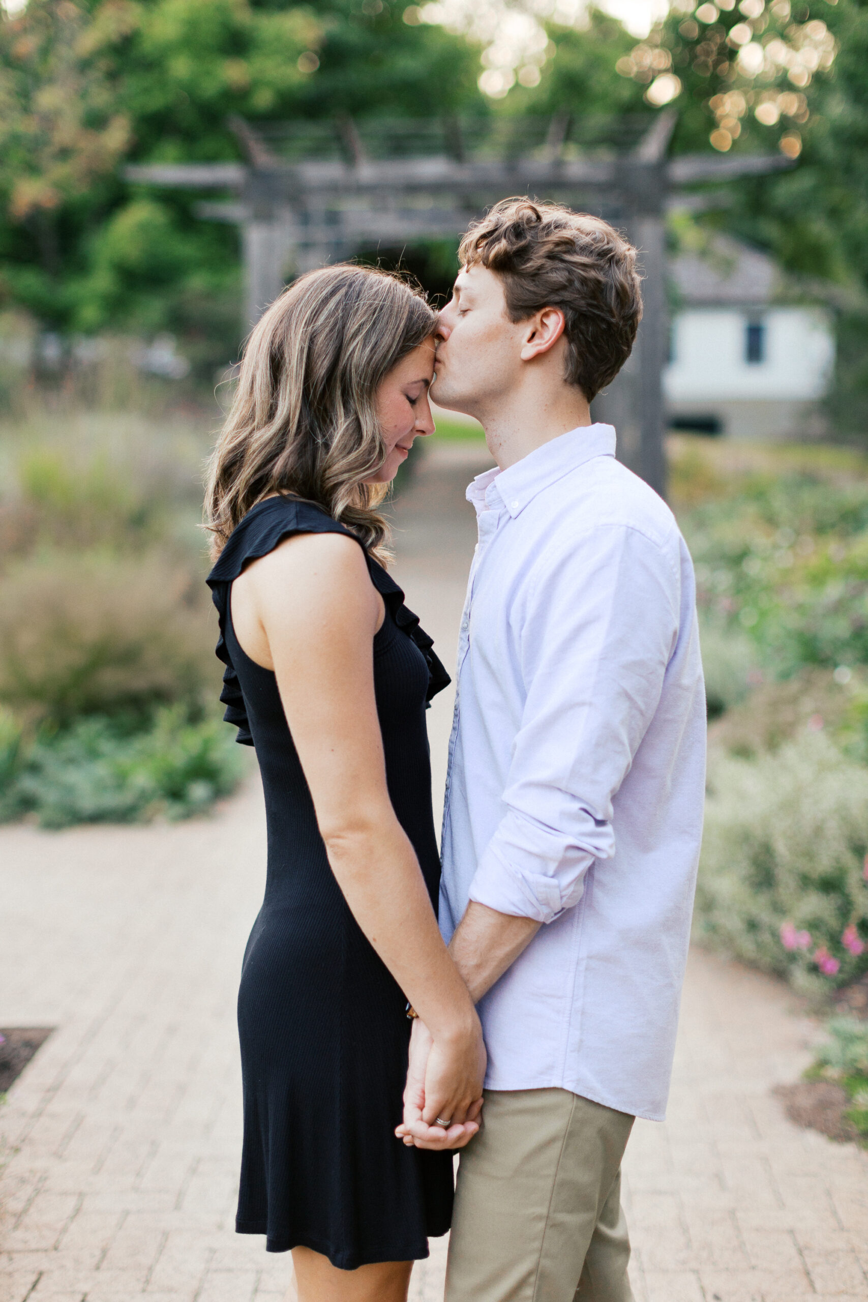 He is kissing her forehead at the Orono Park.