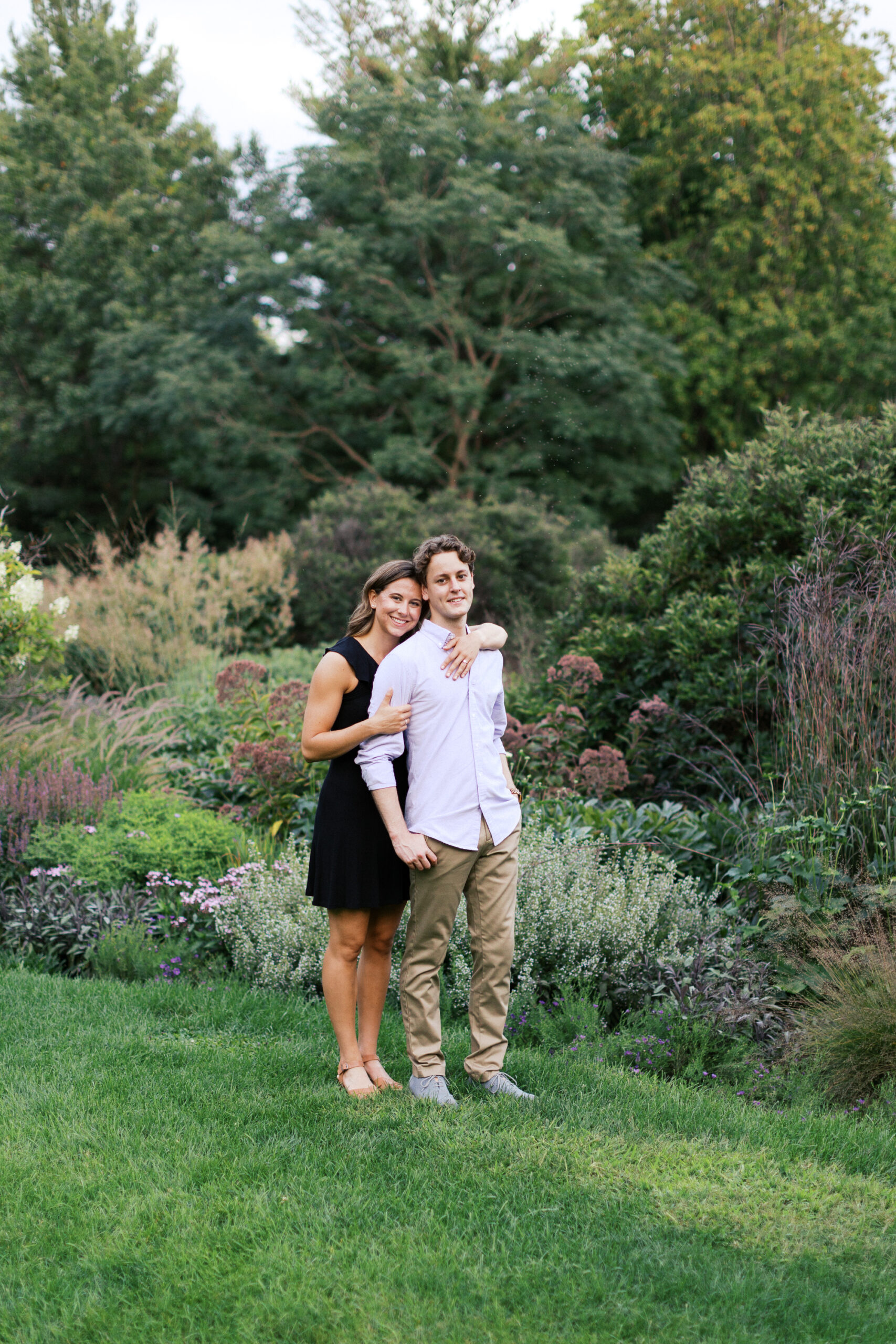 Coupole is standing in the beautiful garden and smiling. 