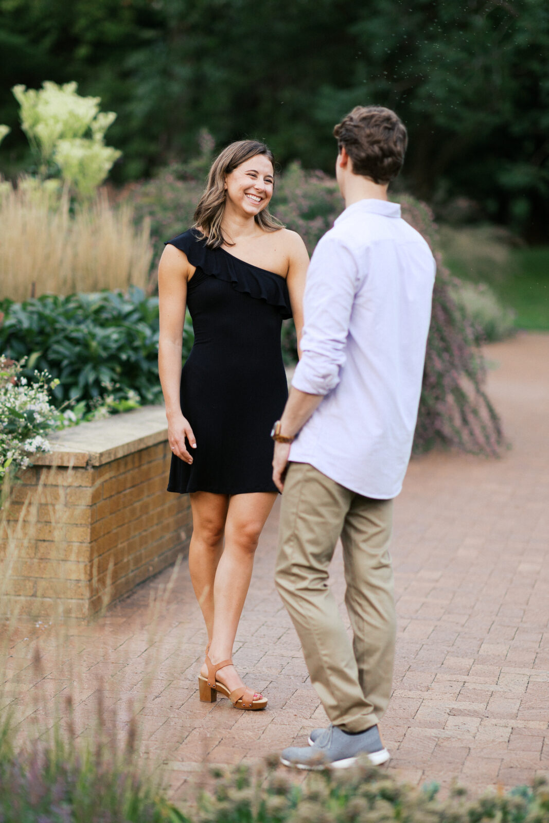 Smiling couple looking at each other holding hands at Waztaa park