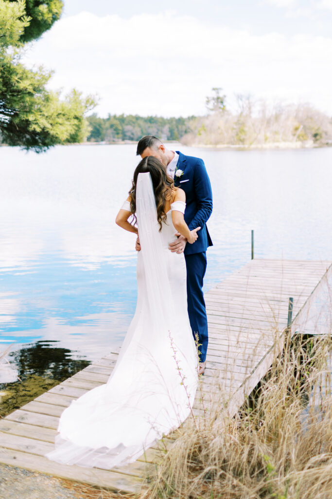 Minnesota Wedding Photographer capturing the first kiss of the bride and groom at Catalyst by Nature Link Resort in Minnesota.